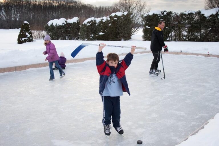Children enjoying ice skating on an outdoor rink in winter.