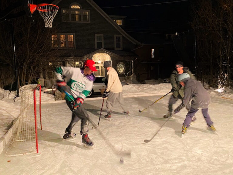 Young hockey player practicing on backyard ice rink in Toronto GTA
