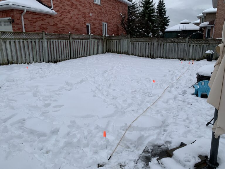 Rinkbuild representative conducting backyard ice rink site assessment in Toronto GTA