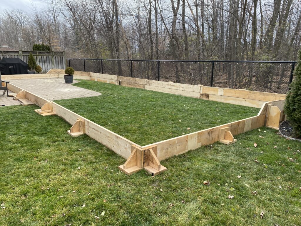Backyard ice rink frame installation in Toronto GTA during fall season